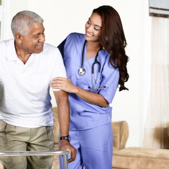 Health care worker helping an elderly man